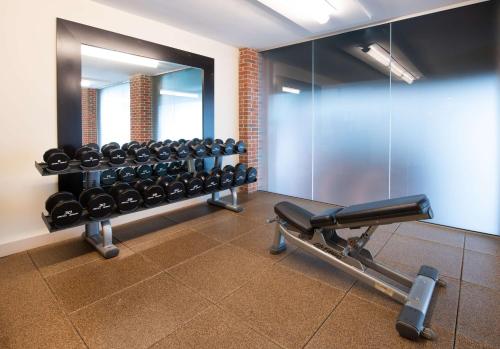 a gym with a rack of dumbbells and a mirror at DoubleTree Hotel & Suites Charleston Airport in Charleston