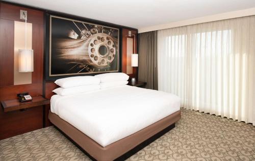 a hotel room with a bed and a painting on the wall at DoubleTree Hotel & Suites Charleston Airport in Charleston