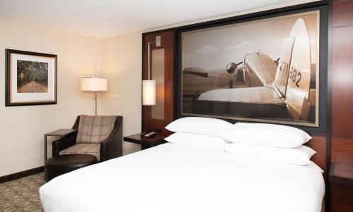 a hotel room with a bed and a chair at DoubleTree Hotel & Suites Charleston Airport in Charleston