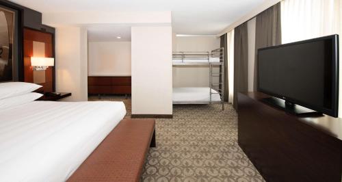 a hotel room with a bed and a flat screen tv at DoubleTree Hotel & Suites Charleston Airport in Charleston
