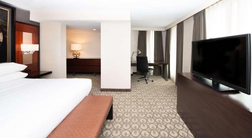 a hotel room with a bed and a flat screen tv at DoubleTree Hotel & Suites Charleston Airport in Charleston