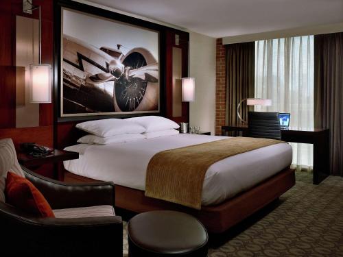 a hotel room with a large bed and a desk at DoubleTree Hotel & Suites Charleston Airport in Charleston