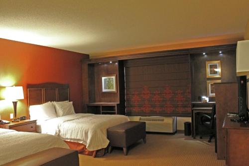 a hotel room with two beds and a desk at Hampton Inn & Suites - Saint Louis South Interstate 55 in Saint Louis