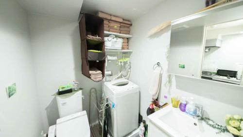 a small kitchen with a refrigerator and a sink at Designer's apartment polaris 101 - Vacation STAY 13314 in Nagoya
