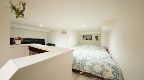 a small bedroom with a bed and a desk at Designer's apartment polaris 101 - Vacation STAY 13314 in Nagoya
