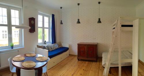 a room with a bed and a table and a bunk bed at Apartment Sopot I in Sopot