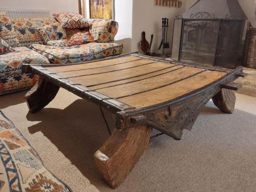a wooden coffee table in a living room with a couch at Stable Cottage - near Lulworth Cove in Dorchester