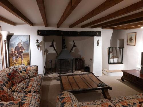 a living room with a couch and a fireplace at Stable Cottage - near Lulworth Cove in Dorchester