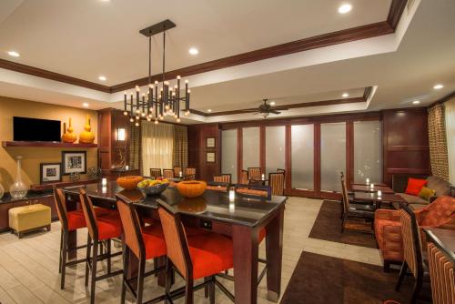 a dining room and living room with a table and chairs at Hampton Inn Kingston in Kingston