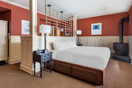 a bedroom with a bed and a wood stove at Hilton Grand Vacations Club Blue Mountain Canada in Blue Mountains