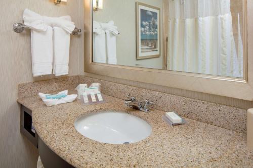 a bathroom with a sink and a mirror at Hilton Garden Inn Plymouth in Plymouth
