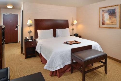 a hotel room with a bed with a tray on it at Hampton Inn & Suites Tacoma in Tacoma