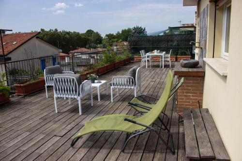 a deck with chairs and a table on a balcony at [Terrazza privata] Venezia Mestre in Marghera