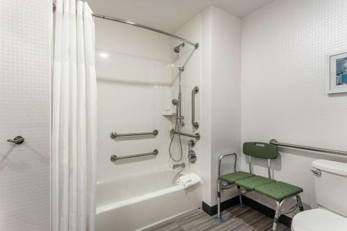 a bathroom with a shower and a toilet at Hampton Inn Oakland Downtown-City Center in Oakland
