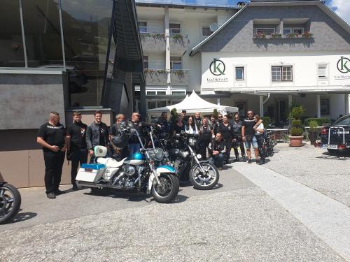 a group of people standing next to a motorcycle at Hotel Kuchlerwirt in Treffen