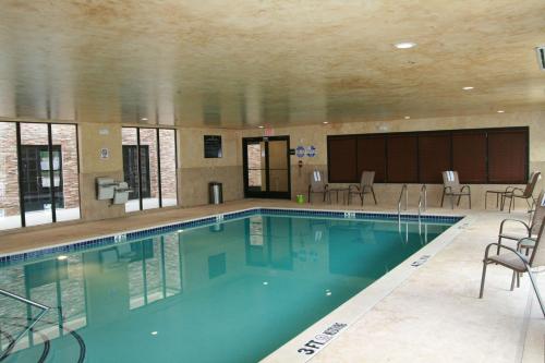 a large swimming pool with chairs in a building at Hampton Inn & Suites Dallas-Arlington North-Entertainment District in Arlington