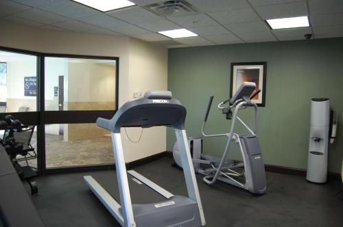 a gym with a treadmill and a elliptical machine at Hampton Inn & Suites McAlester in McAlester