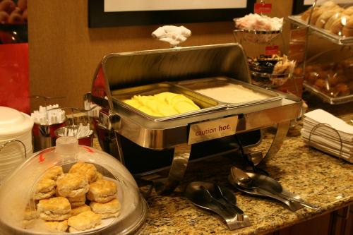 a buffet with pastries on a counter with at Hampton Inn & Suites Ocala - Belleview in Marion Oaks