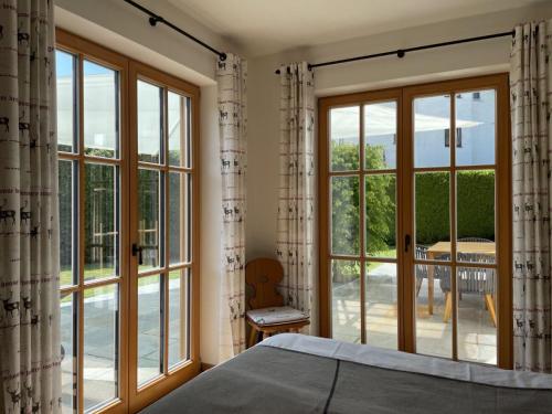 a bedroom with large windows and a view of a patio at Ferienwohnung Max 3 in Garmisch-Partenkirchen
