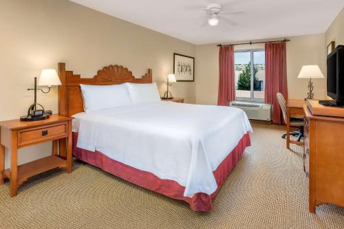a bedroom with a bed and a desk and a television at Homewood Suites by Hilton Santa Fe-North in Pojoaque