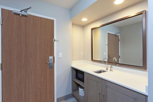 a bathroom with a sink and a mirror at Hampton Inn & Suites Hermosa Beach in Hermosa Beach