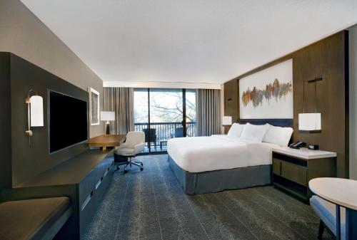 a large hotel room with a bed and a desk at Hilton Peachtree City Atlanta Hotel & Conference Center in Peachtree City