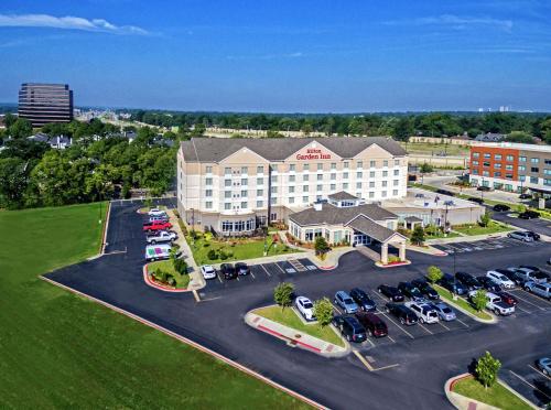 an aerial view of a hotel with a parking lot at Hilton Garden Inn Midtown Tulsa in Tulsa