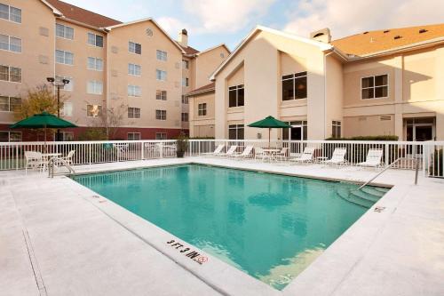 a swimming pool in front of a apartment building at Homewood Suites by Hilton Tallahassee in Tallahassee