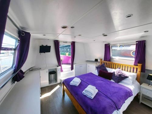a bedroom with a bed in the middle of a van at The Joker Boat in Liverpool