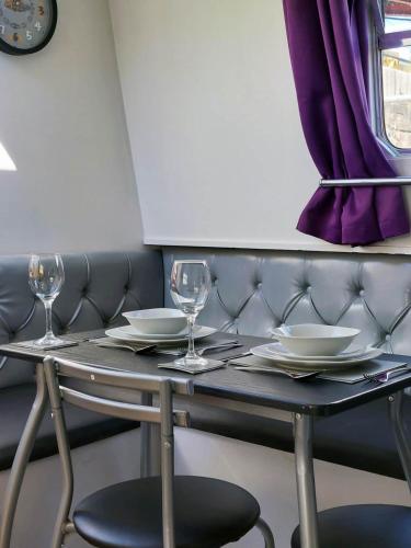 a table with glasses and plates on it at The Joker Boat in Liverpool