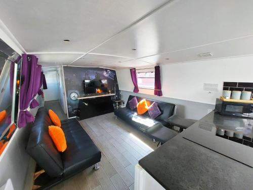 a living room with a couch and a table at The Joker Boat in Liverpool
