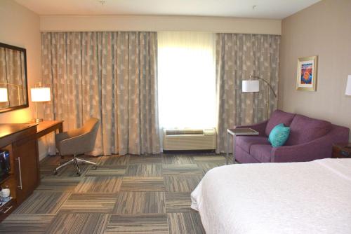 pokój hotelowy z łóżkiem i kanapą w obiekcie Hampton Inn Grand Junction w mieście Grand Junction