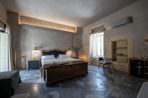 a bedroom with a bed and a table in it at Palazzo Sant'Anna Lecce in Lecce