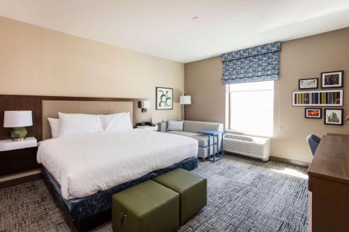 a hotel room with a bed and a window at Hampton Inn & Suites St. George in St. George