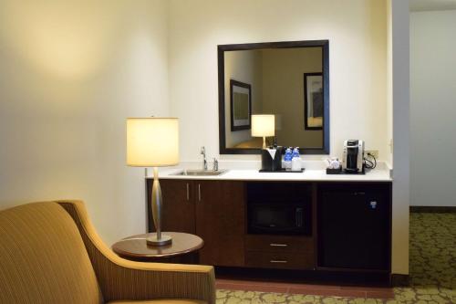 a hotel room with a sink and a mirror at Hilton Garden Inn Rochester Downtown, NY in Rochester