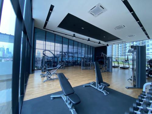 a gym with cardio equipment in a building with windows at Irizz Inn @Homestay Platinum Splendor in Kuala Lumpur