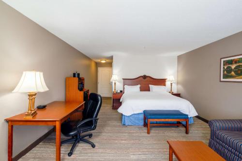 a hotel room with a bed and a desk at Hampton Inn London-North, Ky in London