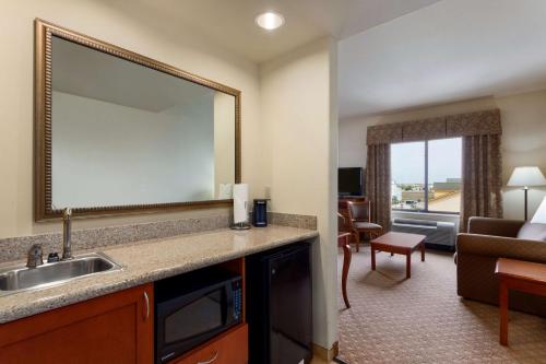 a hotel room with a sink and a living room at Hampton Inn & Suites Pharr in Pharr