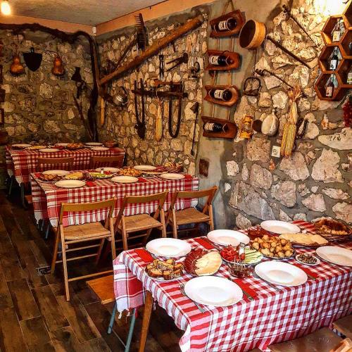 a room with two tables with plates of food on them at Aleksa in Cetinje