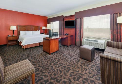 a hotel room with a bed and a large window at Hampton Inn & Suites Fort Worth/Forest Hill in Forest Hill