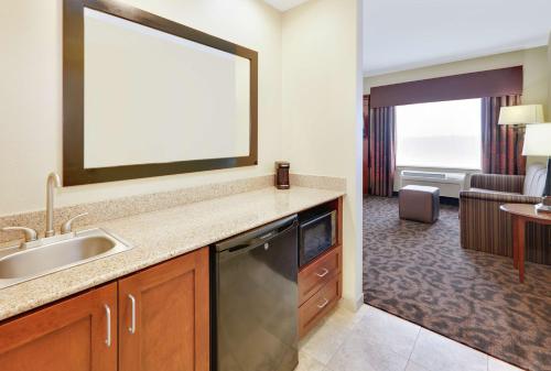 a kitchen with a sink and a living room at Hampton Inn & Suites Fort Worth/Forest Hill in Forest Hill