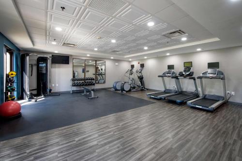 a gym with several treadmills and machines in a room at Hampton Inn Fayetteville in Fayetteville