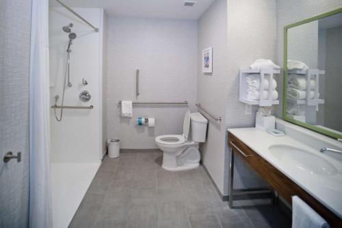 a bathroom with a toilet and a sink at Hampton Inn Fayetteville in Fayetteville