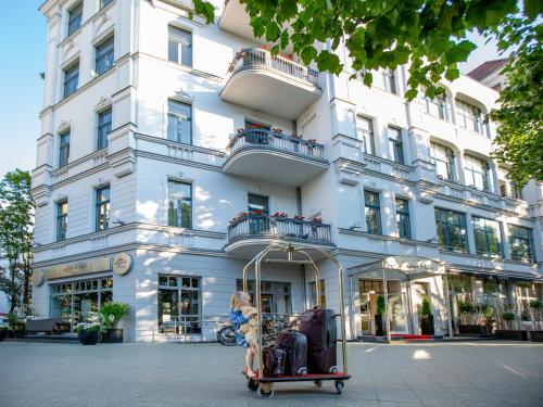 a luggage cart in front of a building at Louisa's Place in Berlin