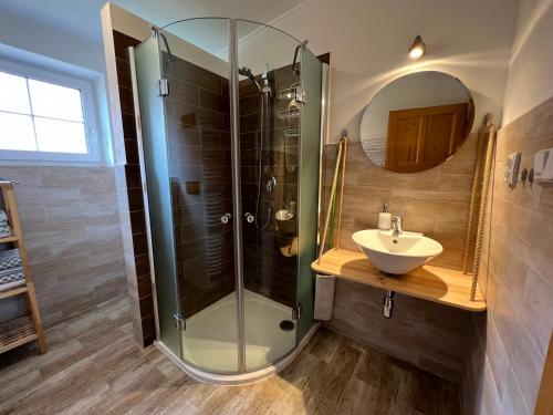 a bathroom with a glass shower and a sink at Apartment Brusinka in Kašperské Hory