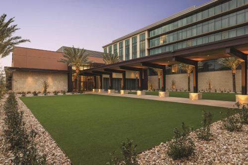 an office building with a lawn in front of it at Hilton North Scottsdale At Cavasson in Scottsdale