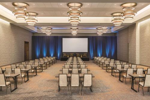 a conference room with chairs and a screen at Hilton North Scottsdale At Cavasson in Scottsdale
