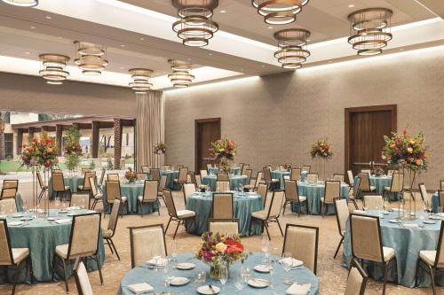 a banquet hall with blue tables and chairs at Hilton North Scottsdale At Cavasson in Scottsdale