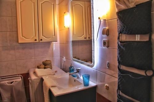 a bathroom with a sink and a mirror at Vaci Deluxe Apartment in Budapest
