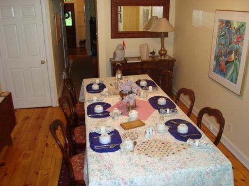 a dining room table with a blue and white table cloth at Australis Guest House in Ottawa